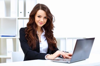 Young pretty business woman with notebook in the office.jpeg